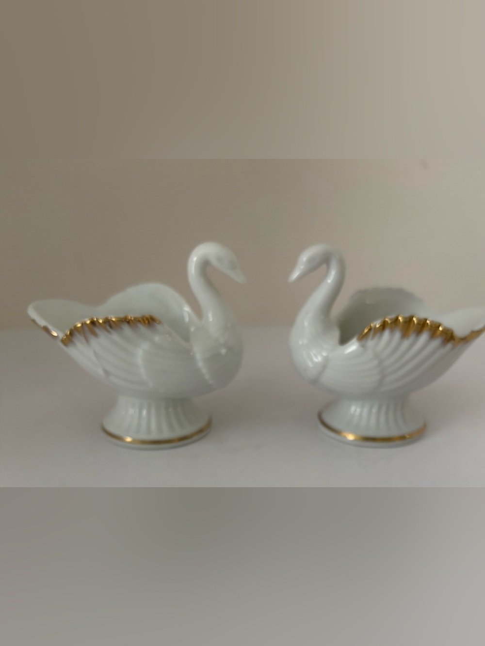 Set of 2 swan candle holders. Ivory bone china w/metallic gold trim. Very nice!